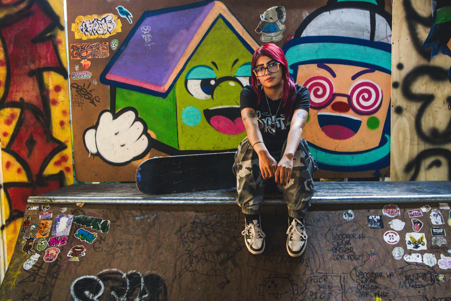 Young woman at an urban graffiti skate park